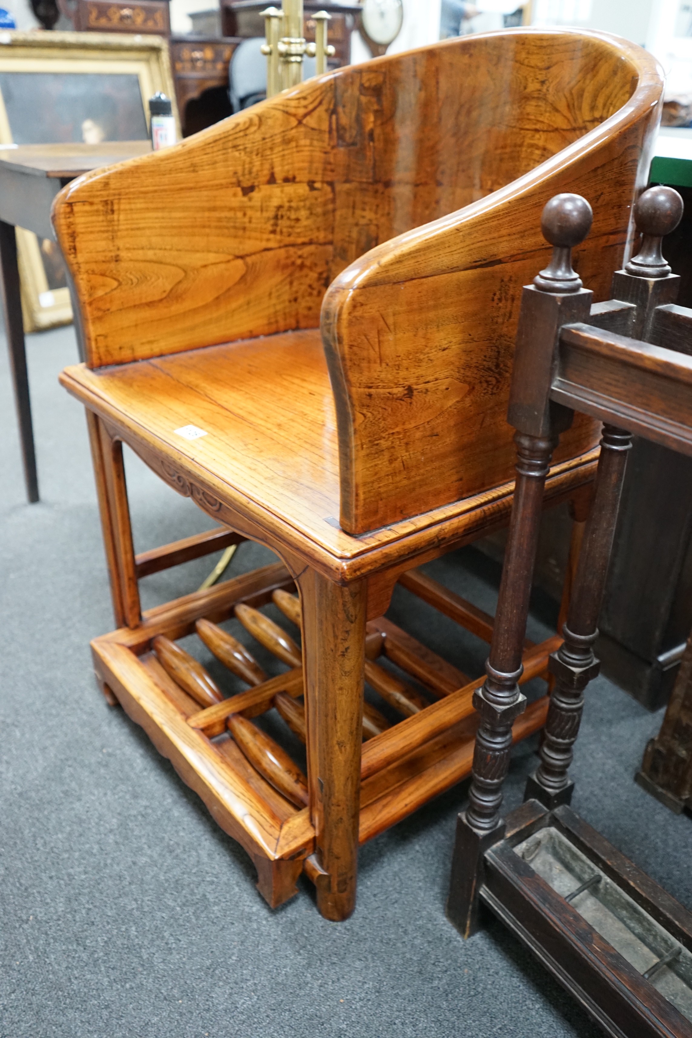 A pair of Chinese elm armchairs with roller footrests, width 57cm, depth 53cm, height 89cm